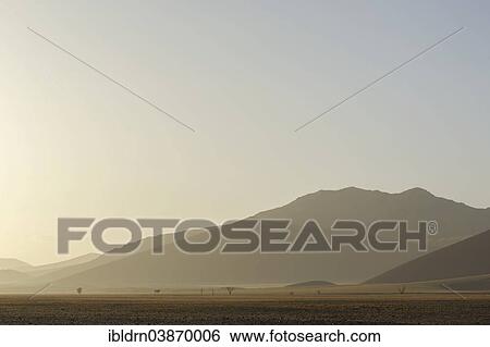Stock Photograph - "Morning haze over the landscape of the Namib Desert, Sesriem, Hardap Region, Namibia, Africa". Fotosearch