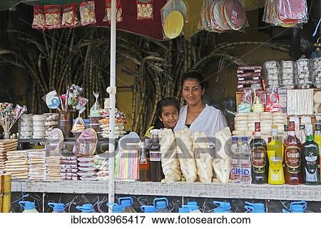 "Mother, 25 years, and daughter, 7 years, selling sweets and drinks made from sugar cane, Puyo, Pastaza Province, Ecuador, South America" View Large Photo Image Stock Photo - "Mother, 25 years, and daughter, 7 years, selling sweets and drinks made from sugar cane, Puyo, Pastaza Province, Ecuador, South America". Fotosearch