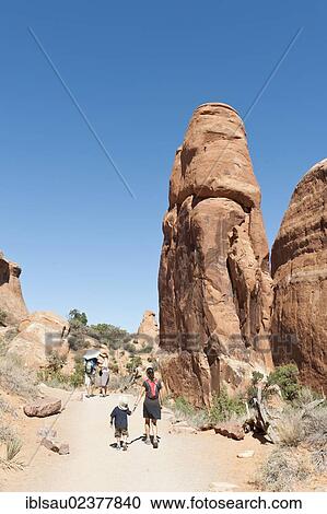 "Mother and child hiking along a trail, red sandstone cliffs, rock formations at Devils Garden Trailhead in Arches National Park, Moab, Utah, Western United States, United States of America, North America" View Large Photo Image Stock Image - "Mother and child hiking along a trail, red sandstone cliffs, rock formations at Devils Garden Trailhead in Arches National Park, Moab, Utah, Western United States, United States of America, North America". Fotosearch