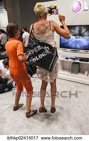 Mother and daughter playing a games console during the Gamescom 2012, Cologne, North Rhine-Westphalia, Germany, Europe View Large Photo Image Stock Photo - Mother and daughter playing a games console during the Gamescom 2012, Cologne, North Rhine-Westphalia, Germany, Europe. Fotosearch
