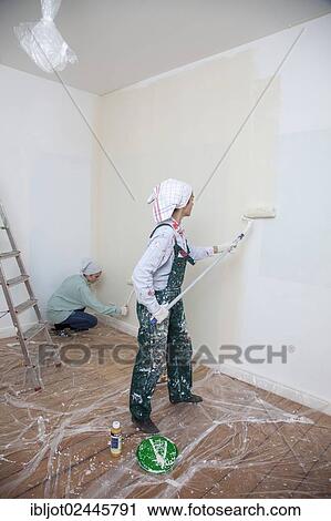 "Mother and daughter renovating a room, painting the walls with paint rollers" View Large Photo Image Stock Image - "Mother and daughter renovating a room, painting the walls with paint rollers". Fotosearch