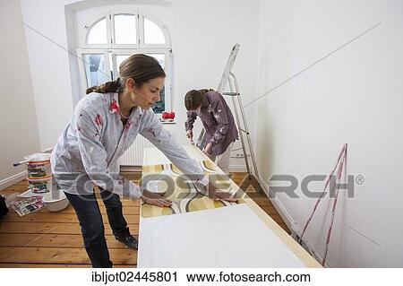 "Mother and daughter renovating a room, wallpapering the walls" View Large Photo Image Stock Image - "Mother and daughter renovating a room, wallpapering the walls". Fotosearch