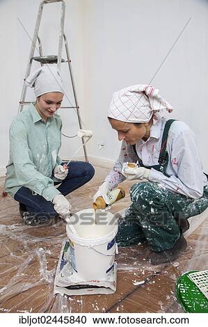 "Mother and daughter renovating a room, tinting paint for painting the walls" View Large Photo Image Stock Image - "Mother and daughter renovating a room, tinting paint for painting the walls". Fotosearch