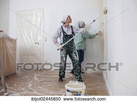 "Mother and daughter renovating a room, painting the walls with paint rollers" View Large Photo Image Stock Image - "Mother and daughter renovating a room, painting the walls with paint rollers". Fotosearch