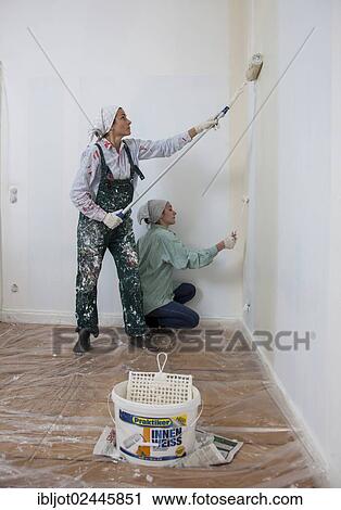 "Mother and daughter renovating a room, painting the walls with paint rollers" View Large Photo Image Stock Image - "Mother and daughter renovating a room, painting the walls with paint rollers". Fotosearch