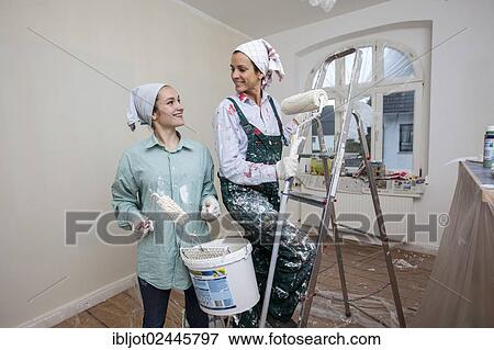 "Mother and daughter renovating a room, painting the walls with paint rollers" View Large Photo Image Stock Photo - "Mother and daughter renovating a room, painting the walls with paint rollers". Fotosearch