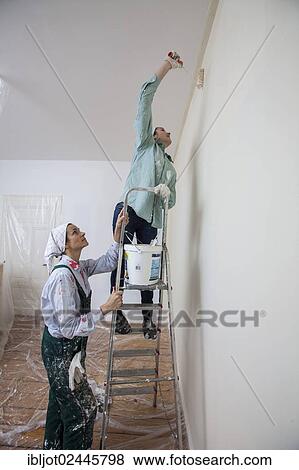 "Mother and daughter renovating a room, painting the walls with paint rollers" View Large Photo Image Stock Photo - "Mother and daughter renovating a room, painting the walls with paint rollers". Fotosearch