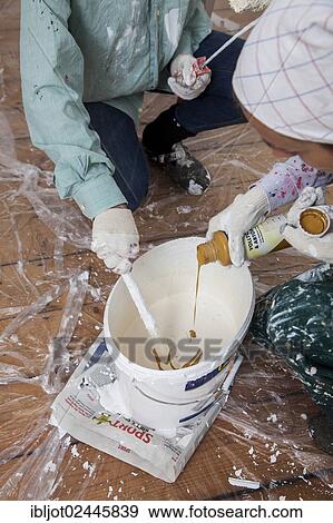 "Mother and daughter renovating a room, tinting paint for painting the walls" View Large Photo Image Stock Photo - "Mother and daughter renovating a room, tinting paint for painting the walls". Fotosearch