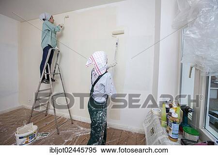 "Mother and daughter renovating a room, painting the walls with paint rollers" View Large Photo Image Stock Photography - "Mother and daughter renovating a room, painting the walls with paint rollers". Fotosearch