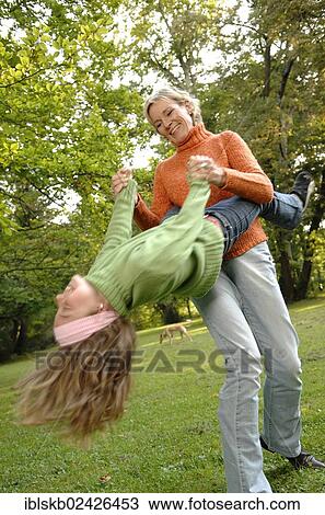 Mother and daughter run around in the park View Large Photo Image Stock Image - Mother and daughter run around in the park. Fotosearch