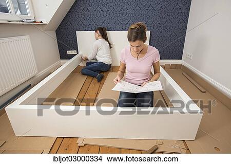 "Mother and daughter working together to assemble a bed in the daughter's room, bed assembly set, Germany, Europe" View Large Photo Image Picture - "Mother and daughter working together to assemble a bed in the daughter's room, bed assembly set, Germany, Europe". Fotosearch