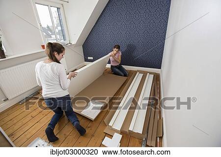 "Mother and daughter working together to assemble a bed in the daughter's room, bed assembly set, Germany, Europe" View Large Photo Image Stock Image - "Mother and daughter working together to assemble a bed in the daughter's room, bed assembly set, Germany, Europe". Fotosearch