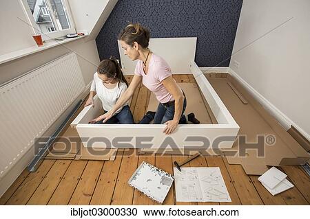 "Mother and daughter working together to assemble a bed in the daughter's room, bed assembly set, Germany, Europe" View Large Photo Image Stock Image - "Mother and daughter working together to assemble a bed in the daughter's room, bed assembly set, Germany, Europe". Fotosearch