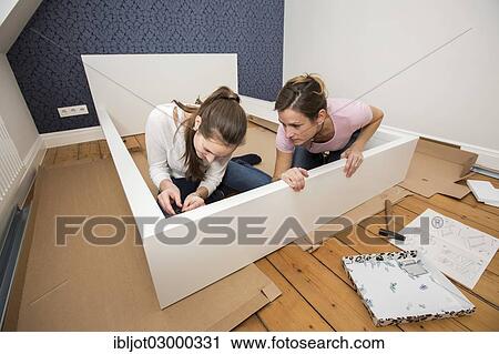 "Mother and daughter working together to assemble a bed in the daughter's room, bed assembly set, Germany, Europe" View Large Photo Image Stock Image - "Mother and daughter working together to assemble a bed in the daughter's room, bed assembly set, Germany, Europe". Fotosearch