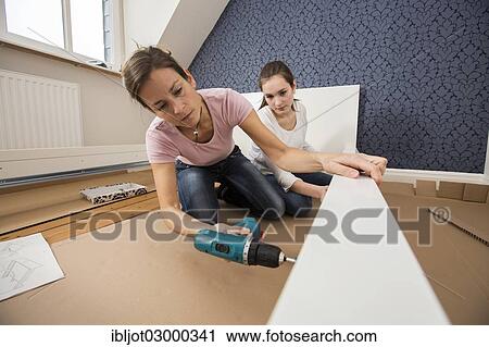 "Mother and daughter working together to assemble a bed in the daughter's room, bed assembly set, Germany, Europe" View Large Photo Image Stock Image - "Mother and daughter working together to assemble a bed in the daughter's room, bed assembly set, Germany, Europe". Fotosearch