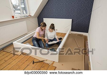 "Mother and daughter working together to assemble a bed in the daughter's room, bed assembly set, Germany, Europe" View Large Photo Image Stock Image - "Mother and daughter working together to assemble a bed in the daughter's room, bed assembly set, Germany, Europe". Fotosearch