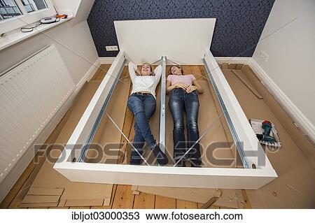 "Mother and daughter working together to assemble a bed in the daughter's room, bed assembly set, Germany, Europe" View Large Photo Image Stock Image - "Mother and daughter working together to assemble a bed in the daughter's room, bed assembly set, Germany, Europe". Fotosearch