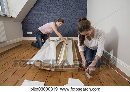 "Mother and daughter working together to assemble a bed in the daughter's room, bed assembly set, Germany, Europe" View Large Photo Image Stock Photo - "Mother and daughter working together to assemble a bed in the daughter's room, bed assembly set, Germany, Europe". Fotosearch