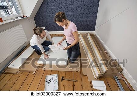 "Mother and daughter working together to assemble a bed in the daughter's room, bed assembly set, Germany, Europe" View Large Photo Image Stock Photo - "Mother and daughter working together to assemble a bed in the daughter's room, bed assembly set, Germany, Europe". Fotosearch