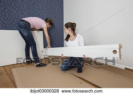 "Mother and daughter working together to assemble a bed in the daughter's room, bed assembly set, Germany, Europe" View Large Photo Image Stock Photo - "Mother and daughter working together to assemble a bed in the daughter's room, bed assembly set, Germany, Europe". Fotosearch