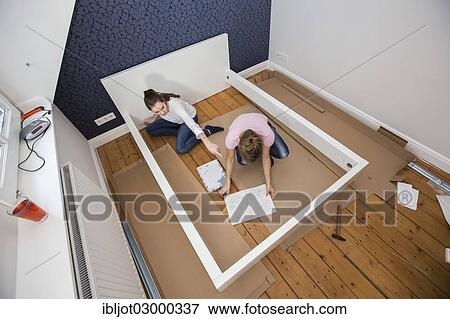 "Mother and daughter working together to assemble a bed in the daughter's room, bed assembly set, Germany, Europe" View Large Photo Image Stock Photo - "Mother and daughter working together to assemble a bed in the daughter's room, bed assembly set, Germany, Europe". Fotosearch