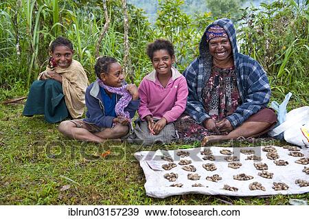 Stock Photo - "Mother and her children selling food in the highlands, Paya, Papua New Guinea, Oceania". Fotosearch