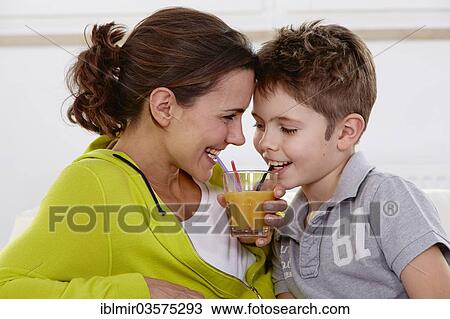 "Mother and son drinking juice from a shared glass, Germany, Europe" View Large Photo Image Stock Image - "Mother and son drinking juice from a shared glass, Germany, Europe". Fotosearch