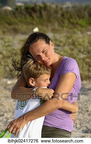 Mother and son hugging each other lovingly, Lefkas, Greece, Europe View Large Photo Image Stock Photograph - Mother and son hugging each other lovingly, Lefkas, Greece, Europe. Fotosearch