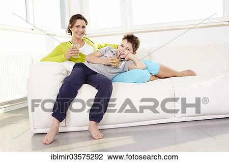 "Mother and son lying on sofa, Germany, Europe" View Large Photo Image Stock Image - "Mother and son lying on sofa, Germany, Europe". Fotosearch
