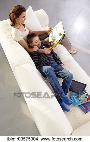 "Mother and son reading on a sofa, Germany, Europe" View Large Photo Image Picture - "Mother and son reading on a sofa, Germany, Europe". Fotosearch
