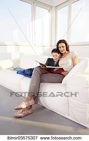 "Mother and son reading on a sofa, Germany, Europe" View Large Photo Image Stock Photo - "Mother and son reading on a sofa, Germany, Europe". Fotosearch