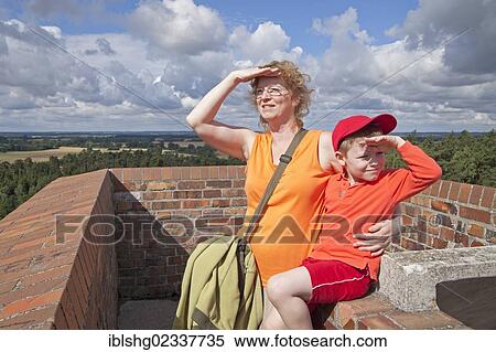 "Mother and son sitting on a viewing tower, Teterow, Mecklenburgische Schweiz region, Mecklenburg-Western Pomerania, Germany, Europe" View Large Photo Image Stock Photography - "Mother and son sitting on a viewing tower, Teterow, Mecklenburgische Schweiz region, Mecklenburg-Western Pomerania, Germany, Europe". Fotosearch