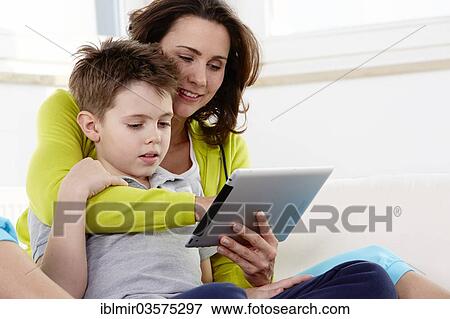 Stock Photo - "Mother and son using a tablet pc, Germany, Europe". Fotosearch