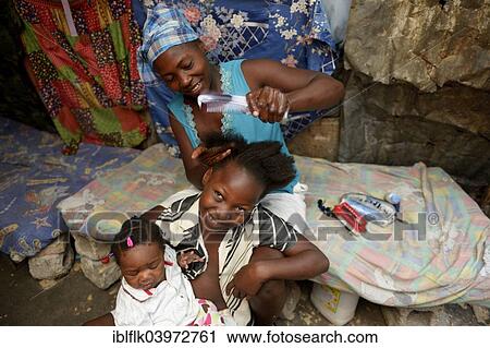 "Mother braiding in her daughter's hair, Camp Icare, camp for earthquake refugees, Fort National, Port-au-Prince, Haiti, North America" View Large Photo Image Stock Image - "Mother braiding in her daughter's hair, Camp Icare, camp for earthquake refugees, Fort National, Port-au-Prince, Haiti, North America". Fotosearch