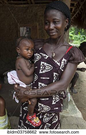 "Mother holding a child, Tiwai Island, Southern Province, Sierra Leone, Africa" View Large Photo Image Stock Image - "Mother holding a child, Tiwai Island, Southern Province, Sierra Leone, Africa". Fotosearch