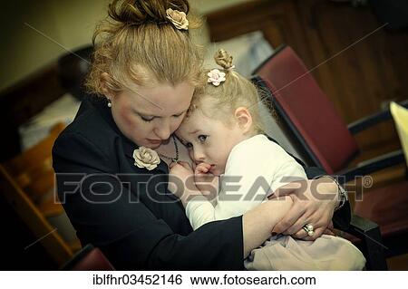 "Mother holding her little daughter in her arms protectively, Germany, Europe" View Large Photo Image Stock Photograph - "Mother holding her little daughter in her arms protectively, Germany, Europe". Fotosearch