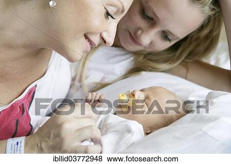 Mother in the hospital with her older daughter and a newborn baby View Large Photo Image Stock Photo - Mother in the hospital with her older daughter and a newborn baby. Fotosearch