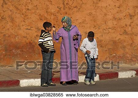 "Mother in traditional dress with djellaba and headscarf, with her two sons in western clothing, Medina or historic centre, Marrakech, Morocco, Africa" View Large Photo Image Stock Photography - "Mother in traditional dress with djellaba and headscarf, with her two sons in western clothing, Medina or historic centre, Marrakech, Morocco, Africa". Fotosearch