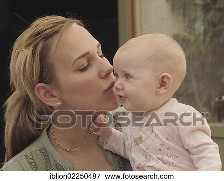 Stock Photo - "Mother kissing her baby, 6 months". Fotosearch