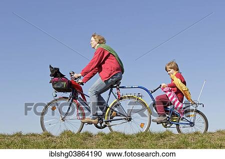 "Mother, son and a dog on a bicycle tour" View Large Photo Image Stock Image - "Mother, son and a dog on a bicycle tour". Fotosearch