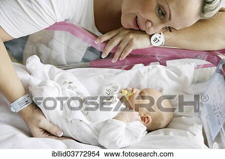 Picture - Mother with her newborn baby. Fotosearch