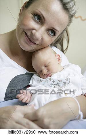 Mother with her newborn baby View Large Photo Image Stock Image - Mother with her newborn baby. Fotosearch