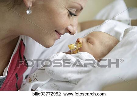Stock Image - Mother with her newborn baby. Fotosearch