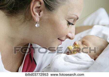 Mother with her newborn baby View Large Photo Image Stock Image - Mother with her newborn baby. Fotosearch
