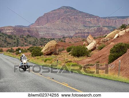 "Motorcycle driving on the U. S. Highway 24, Waterpocket Fold, Capitol Reef National Park, Utah, Southwestern USA" View Large Photo Image Stock Photography - "Motorcycle driving on the U. S. Highway 24, Waterpocket Fold, Capitol Reef National Park, Utah, Southwestern USA". Fotosearch