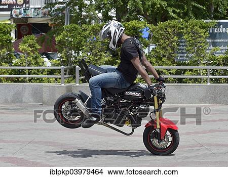 "Motorcycle stunt rider performing, Cha Am, Thailand, Asia" View Large Photo Image Picture - "Motorcycle stunt rider performing, Cha Am, Thailand, Asia". Fotosearch