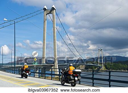 Stock Image - "Motorcycles on the European Road E39 at Stord Bridge or Stordabrua suspension bridge across the sound of Digernessundet, road link between the islands of Stord and Foyno, Stord, Norway, Europe". Fotosearch