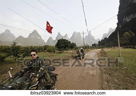 "Motorcyclist in front of karst mountains in Yangshuo, China, Asia" View Large Photo Image Picture - "Motorcyclist in front of karst mountains in Yangshuo, China, Asia". Fotosearch