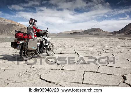 "Motorcyclist travelling on the Pamir Highway, M41, Province of Gorno-Badakhshan, Tajikistan, Asia" View Large Photo Image Stock Photo - "Motorcyclist travelling on the Pamir Highway, M41, Province of Gorno-Badakhshan, Tajikistan, Asia". Fotosearch
