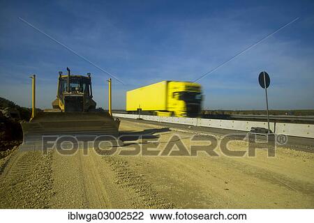 Stock Image - "Motorway road works, expansion of the A8 Autobahn, motorway, to a total of 6 lanes, earth moving machine, Schwabische Alb, Dornstadt, Baden-Wurttemberg, Germany, Europe". Fotosearch
